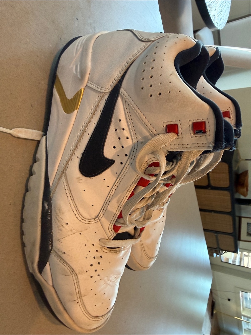 Nike Men’s White Leather Sneakers with Black and Gold Accents